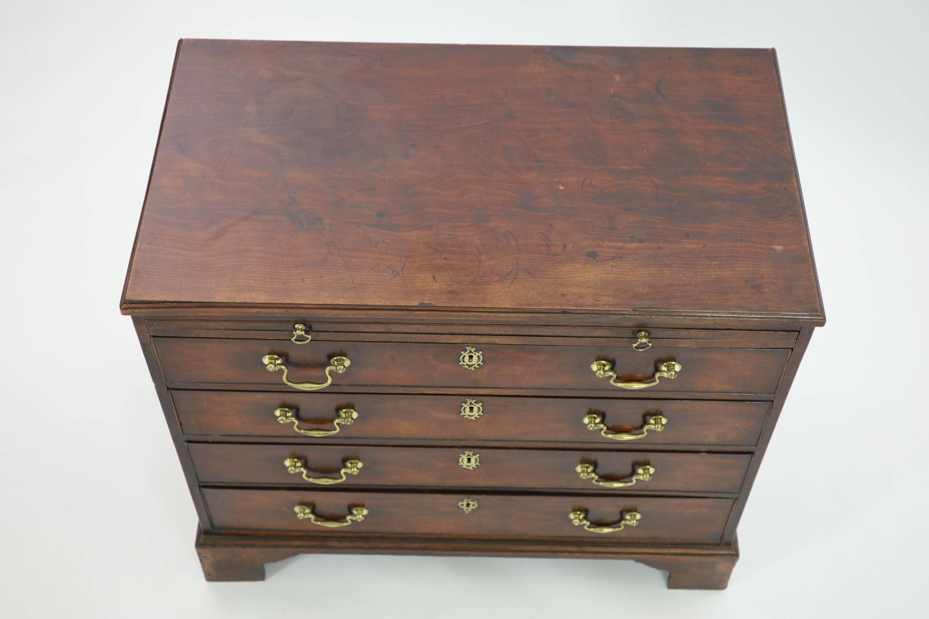 A George III mahogany chest of four graduated long drawers with brushing slide W 93cm D 52cm. H 83cm.